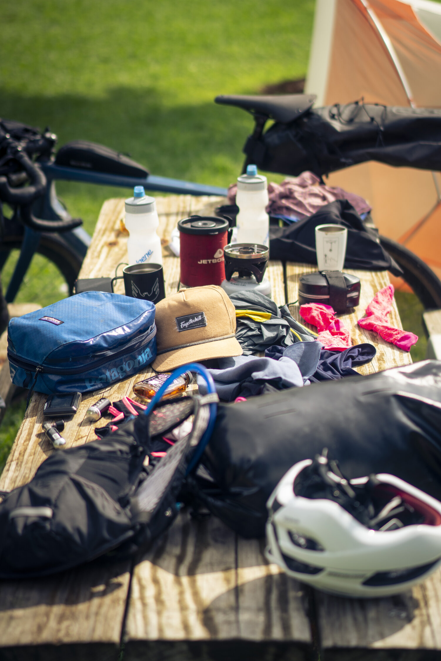 Camping gear gathered on a picnic table.
