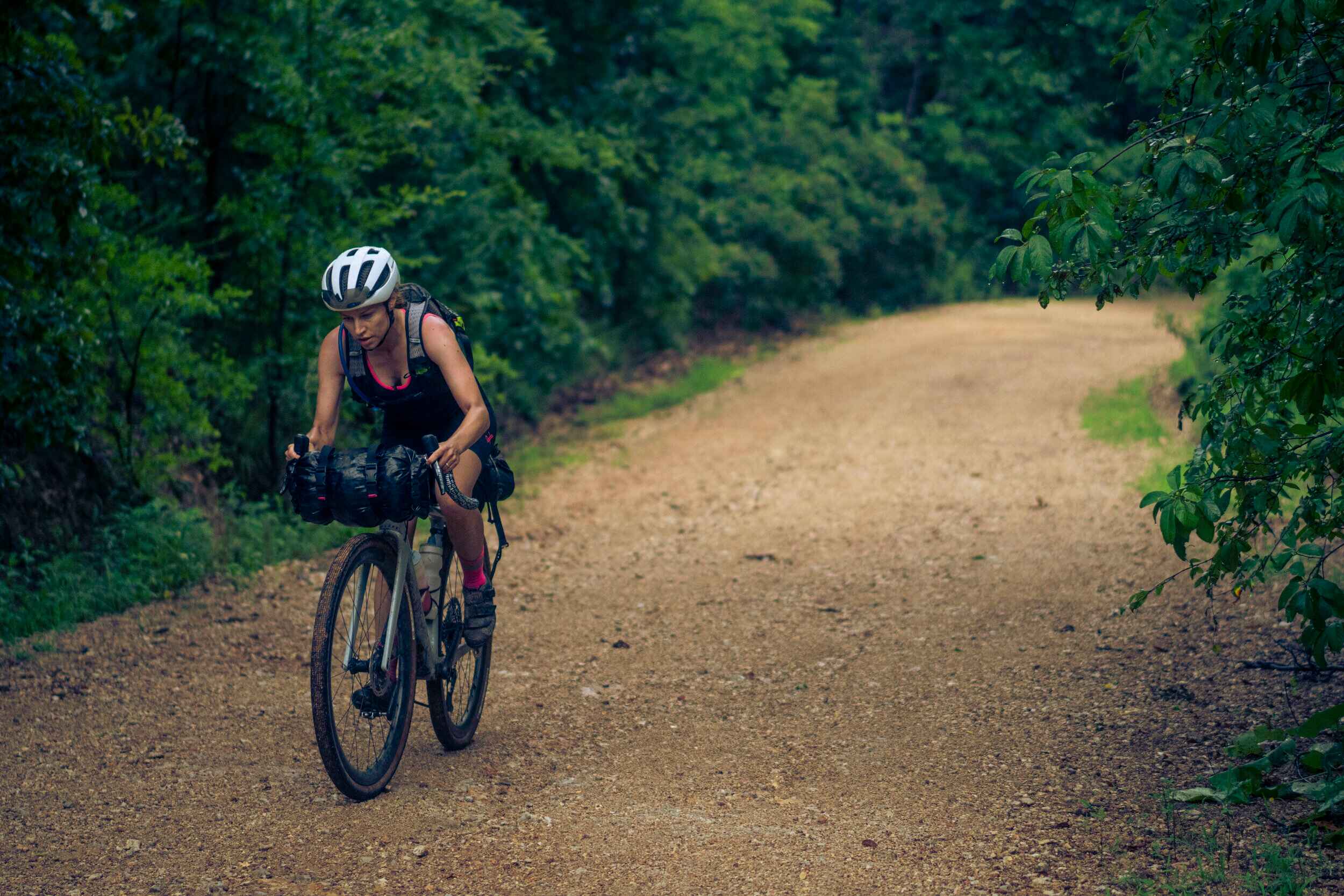 Female bike rider riding up a gravel climb