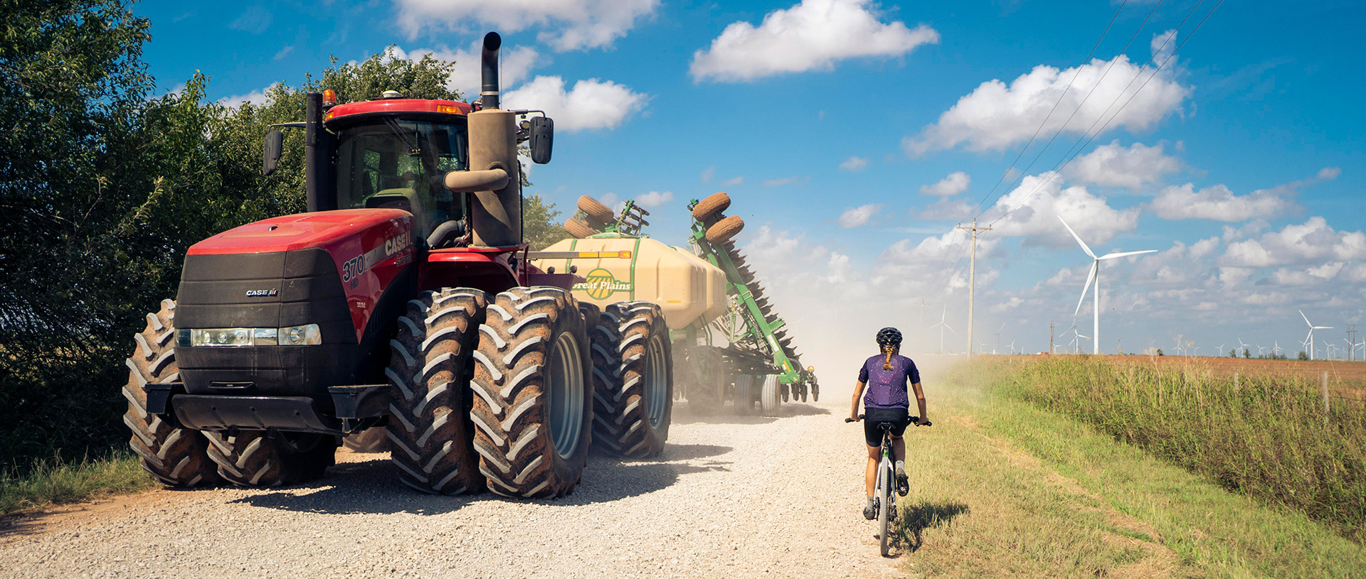 OZ Gravel road with rider, tractor, and windmill