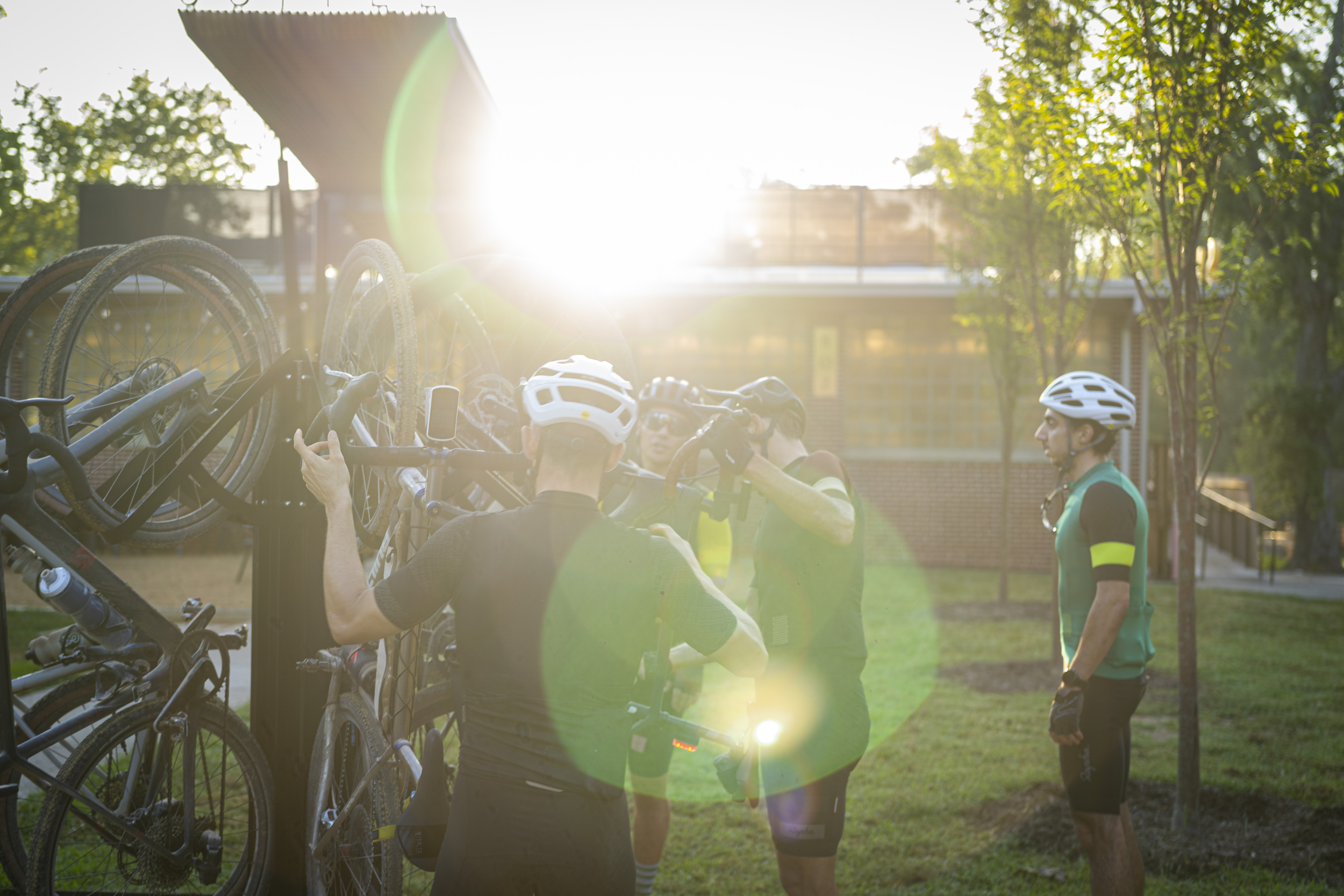 Bike riders load their bikes onto the rack in front of Airship Coffee.