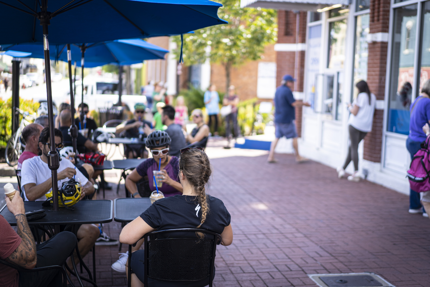 Four people enjoy and soda and ice cream at the Spark Cafe on the Downtown Bentonville square.