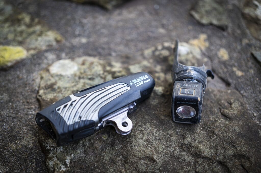 Close up image of a front bike light and rear bike light.