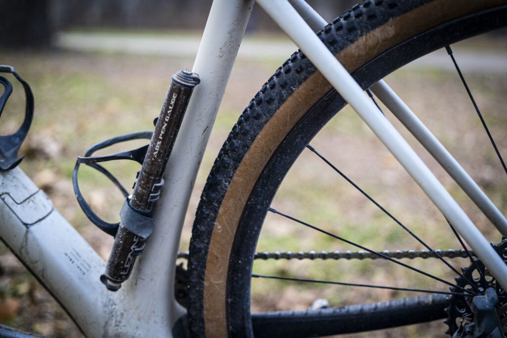 Hand-pump resting on a bike frame.